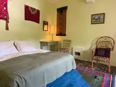 a bedroom with a bed and a desk and a chair at Belle de Nuit in Oppède