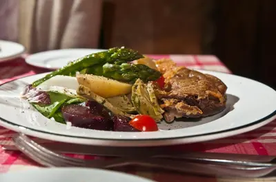 a plate of food with vegetables on a table at Belle de Nuit in Oppède