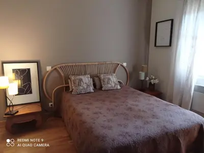 a bedroom with a bed with two pillows on it at La Maison de Maïté in Cheval-Blanc