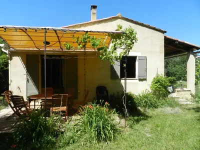 a house with a table and chairs in front of it at Maison d'artiste in Gargas