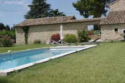 a house with a swimming pool in the yard at Gîtes dans Mas en pierres in Robion en Luberon
