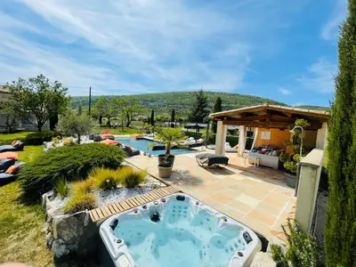 a backyard with a hot tub in a yard at La Bastide des Bourguets Adults Only, Mont Ventoux in Sault-de-Vaucluse