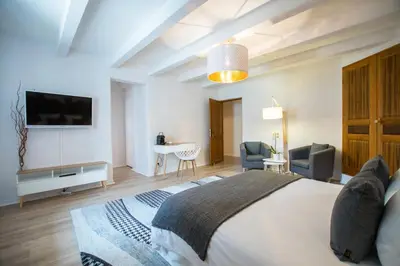 a bedroom with a bed and a table with chairs at La Bastide des Bourguets Adults Only, Mont Ventoux in Sault-de-Vaucluse