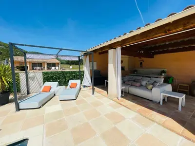 a patio with a couch and chairs on a patio at La Bastide des Bourguets Adults Only, Mont Ventoux in Sault-de-Vaucluse