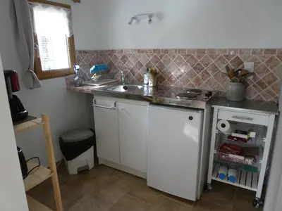 a small kitchen with a sink and a counter at Les Biguières in Maubec