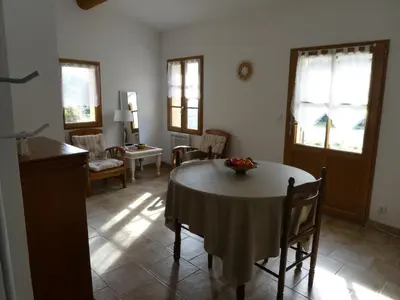 a kitchen and dining room with a table and chairs at Les Biguières in Maubec