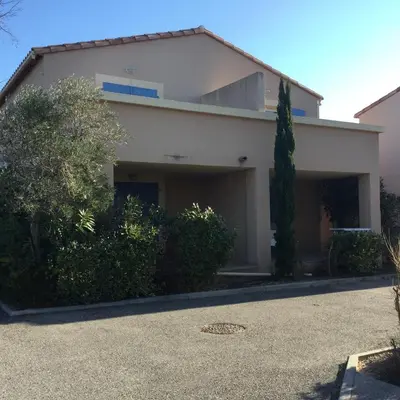 a white house with trees and a driveway at Charming rental with shared-pool in the Alpilles. in Mouriès