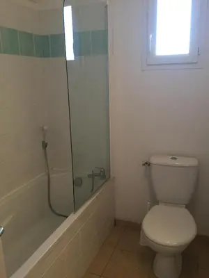 a bathroom with a toilet and a glass shower at Charming rental with shared-pool in the Alpilles. in Mouriès