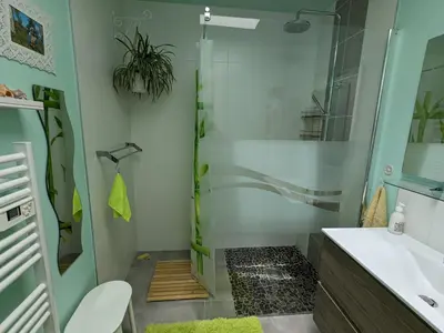 a sliding glass door in a room with a mirror at La Maison sous l'olivier in Morières-lès-Avignon