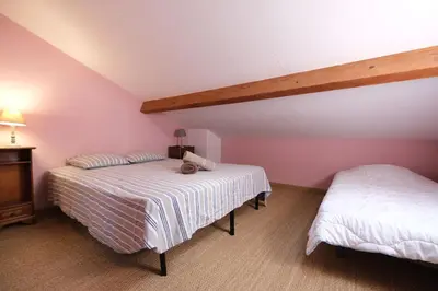 two beds in a room with pink walls at Nice house with private-pool situated in the heart of the Luberon in Maubec