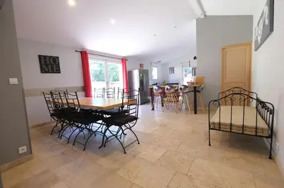 a dining room and living room with a table and chairs at Nice house with private-pool situated in the heart of the Luberon in Maubec