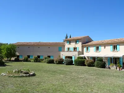 a large building with a yard in front of it at Cante Grillet - 295 Chemin des Contards - 84480 Lacoste in Lacoste