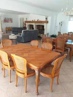 a wooden table and chairs in a living room at Cante Grillet - 295 Chemin des Contards - 84480 Lacoste in Lacoste