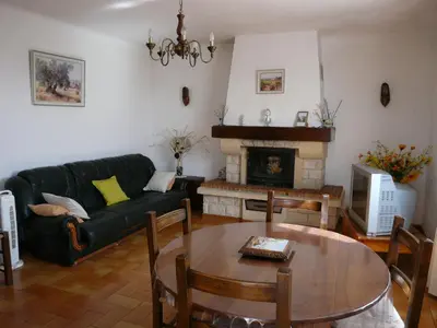 a living room with a couch and a table at Spacious villa on two levels in Cabrières-dʼAvignon