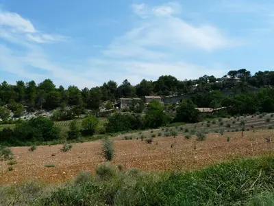 a field with trees and houses on a hill at 19th century Provencal Mas with pool in Provence in the Luberon, sleeps 6 in Lacoste