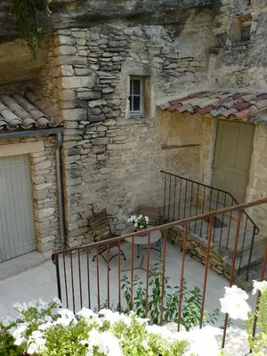 a stone building with a staircase and a window at 19th century Provencal Mas with pool in Provence in the Luberon, sleeps 6 in Lacoste