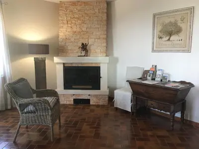 a living room with a fireplace and a piano at vacation home with private swimming-pool and a nice view on the luberon mountain, located in merindol, 8 persons in Mérindol