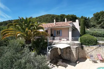 a villa with a palm tree and a house at vacation home with private swimming-pool and a nice view on the luberon mountain, located in merindol, 8 persons in Mérindol