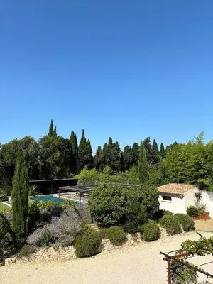 a view of a garden with a swimming pool at Le Mas des Mirabelles in Cabannes