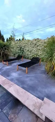 a group of benches sitting in a parking lot at Le Mas des Mirabelles in Cabannes