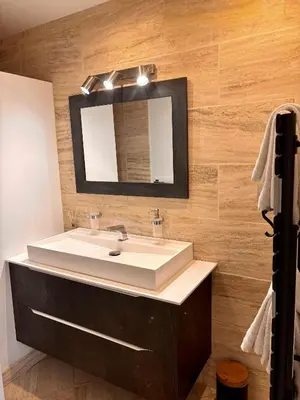 a bathroom with a white sink and a mirror at Le Mas des Mirabelles in Cabannes