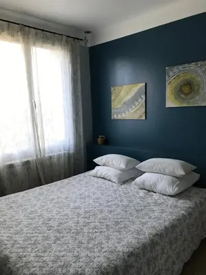a bedroom with a large bed with two pillows at L'Atelier des Coudelières in Le Thor