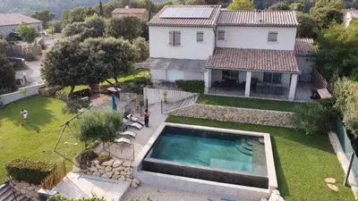 an aerial view of a house with a swimming pool at La cubaine in Puget