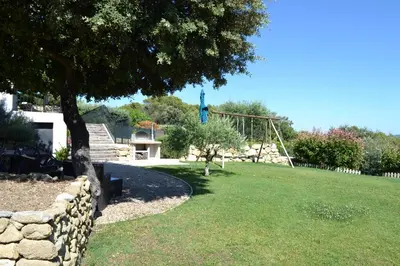 a park with a swing set in the grass at La cubaine in Puget