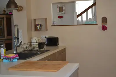 a kitchen with a counter with a cutting board on it at La cubaine in Puget
