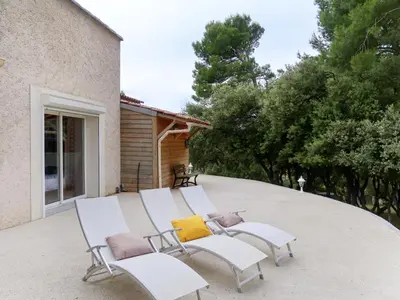 a group of white chairs sitting on a patio at Holiday Home Luberon Vidauque by Interhome in Cavaillon