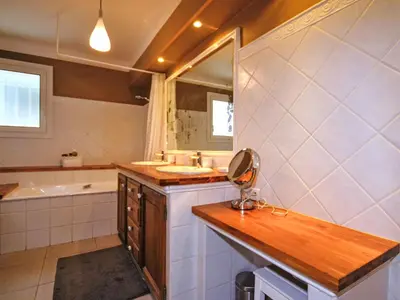 a bathroom with a sink and a tub and a mirror at Holiday Home Luberon Vidauque by Interhome in Cavaillon
