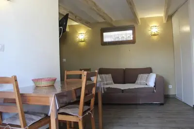 a living room with a table and a couch at Maison de charme à Mérindol + Jardin in Mérindol