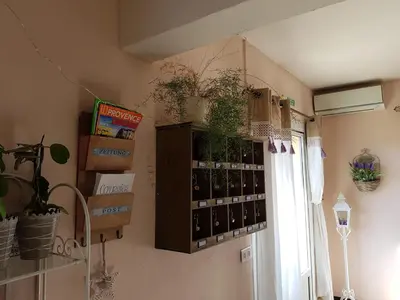 a room with a bunch of wine bottles on the wall at Hotel Carina in Apt