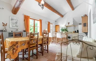 a kitchen and dining room with a table and chairs at Cozy Home In Pernes Les Fontaines in Pernes-les-Fontaines
