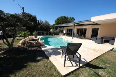 a swimming pool in a yard with a chair next to it at very pretty contemporary villa with pool located in Aureille in the alpilles, close to the center on foot. sleeps 4. in Aureille