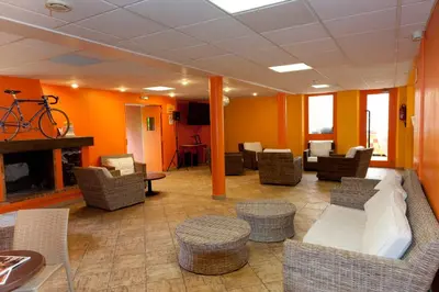 a waiting room with chairs and a bike on the wall at VTF Les Florans in Bédoin