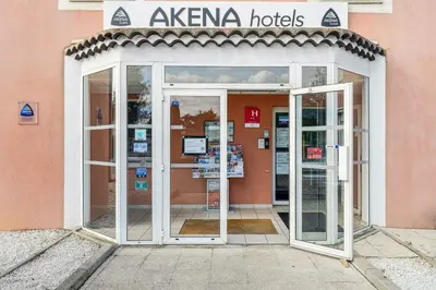 an entrance to a building with an open door at Hôtel AKENA Chateaurenard - Parc des Expositions Avignon in Châteaurenard