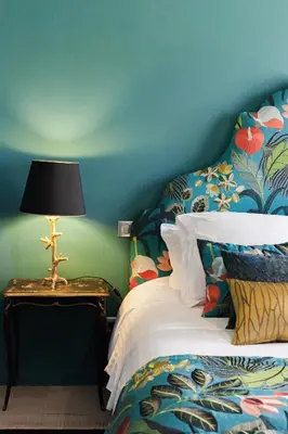a bedroom with a bed and a table with a lamp at Maison Du Collectionneur in Aix-en-Provence