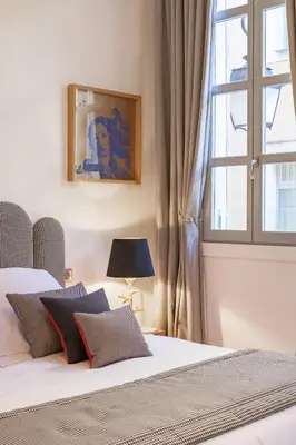a bedroom with a bed and a window at Maison Du Collectionneur in Aix-en-Provence