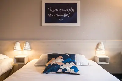 a bedroom with a bed with a pillow on it at Ace Hôtel Salon de Provence in Salon-de-Provence