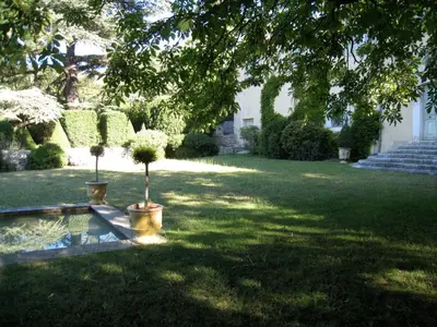 a garden with two potted trees in a yard at Bastide de Ganay - Saint Jérôme in Aix-en-Provence