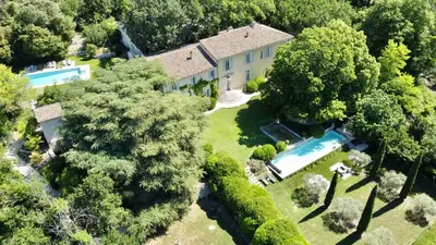 an aerial view of a house with a swimming pool and trees at Bastide de Ganay - Saint Jérôme in Aix-en-Provence