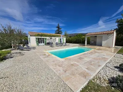 a villa with a swimming pool in front of a house at Villa Chapperon in Bédoin