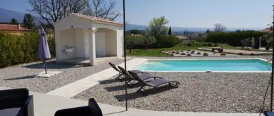 a swimming pool with a chair next to a house at Villa Chapperon in Bédoin