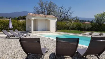a group of chairs sitting next to a swimming pool at Villa Chapperon in Bédoin