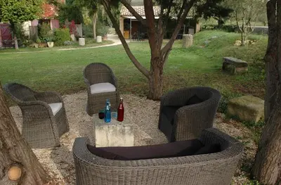 a picnic area with two chairs and a table with drinks at La Tuilière en Luberon in Cadenet