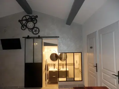 a room with a clock on the wall at Gite Le city en Provence in Lambesc