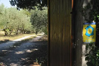 a yellow and blue sign on a wall next to a road at un lit en provence in Éguilles