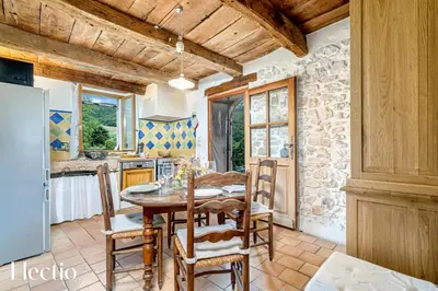 a kitchen and dining room with a table and chairs at Mas La Miellerie - Charme Authentique et Nature in Simiane-la-Rotonde