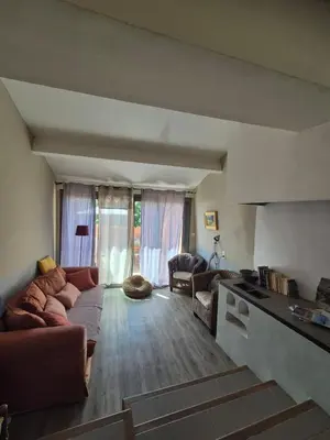 a living room with a couch and a table at 40 Rue du Ventoux in Bédoin